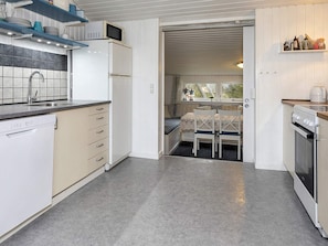 A compact kitchen with a built-in dishwasher, a microwave, and a stove.
