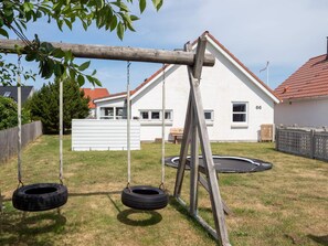 A residential property with a swing set, a trampoline, and a white house with a red roof. - 4 Star Holiday Home in Thisted (Thisted)