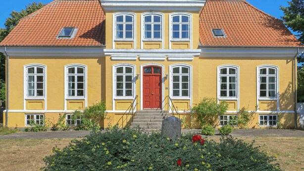 A yellow building with a red door, multiple windows, and a red roof. - Vintage Holiday Home in Syddanmark With Private Whirlpool (Sydlangeland)