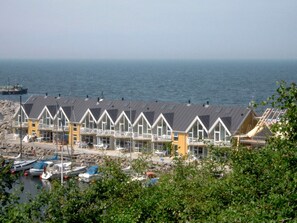 A row of beach houses with a view of the sea.