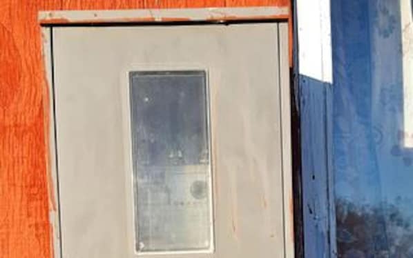 A door with a small window, a metal handle, and a rectangular panel. - Vibrant Holiday Home in RÃ¸mÃ¸ near Sea (Rømø)