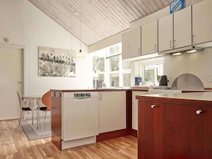 Enjoy cooking in this well-equipped kitchen with a dishwasher and large window offering a view of the outdoors.