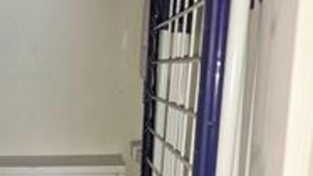 A door with a metal security gate, a white door panel, and a blue frame. - 5 Star Holiday Home in Romo (Rømø)