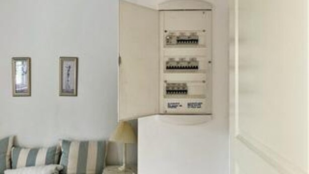 A room with a white wall, a framed picture, a lamp, and an electrical panel. - Cozy Holiday Home in Nykobing Sjaelland near Fishing Village (Nykobing Sjaelland)
