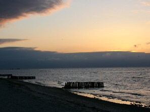 A beach with wooden piers extending into the water.
