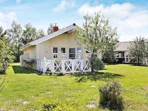 A single-story house with a covered porch, a visible chimney, and a number '48' on the side. - Holiday Home in Otterndorf (Otterndorf)