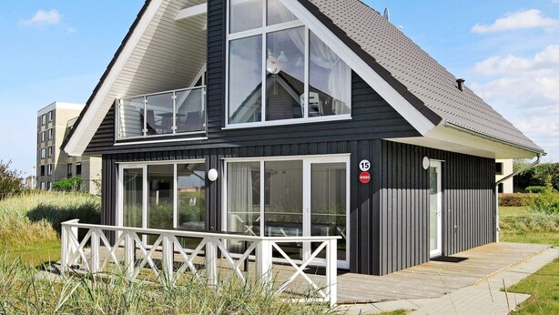 A modern two-story building with large windows and a balcony. - Holiday Home in Wendtorf (Wendtorf)