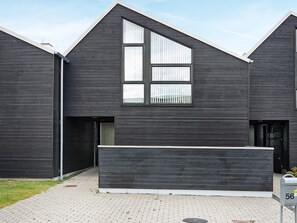 A modern building with a dark facade, a large window, and a mailbox with the number 56. - 8 Person Holiday Home in Hadsund-by Traum (Hadsund)