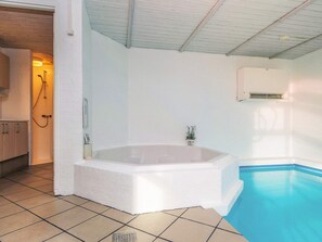 A bathroom with a bathtub, a shower, and a small pool. - 4 Star Holiday Home in Nordborg (Nordborg)