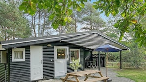 A small, single-story cabin with a patio area.