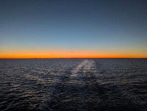 A calm sea with a clear horizon and a visible wake from a moving vessel. - 12 Person Holiday Home in Laeso-by Traum (Læsø)