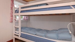 A bunk bed with two levels, each with a mattress and pillows. - 12 Person Holiday Home in Laeso-by Traum (Læsø)