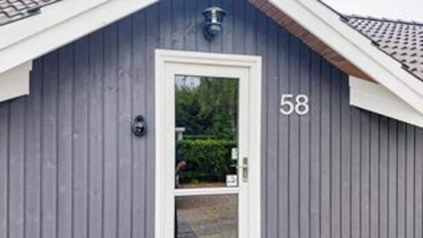A building with a white door and the number 58 on its side. - 4 Star Holiday Home in Hovborg (Hovborg)
