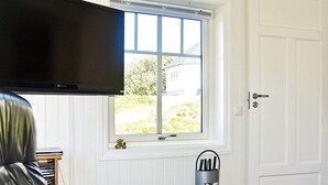 A room with a television, a window with a view of greenery, a door, and a metal rack. - 4 Star Holiday Home in Oksvoll (Orland)