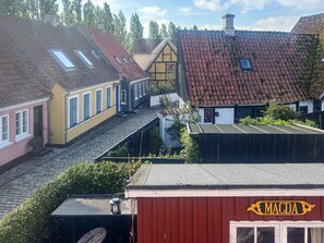A traditional European village with cobblestone streets, historic buildings with red-tiled roofs, and a prominent red building labeled 'MAGDA'. - 4 Person Holiday Home in Aeroskobing (Aeroskobing)
