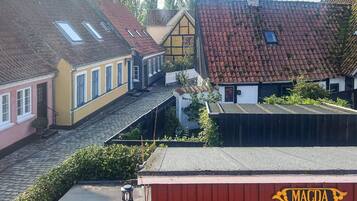 A traditional European village with cobblestone streets, historic buildings with red-tiled roofs, and a prominent red building labeled 'MAGDA'.