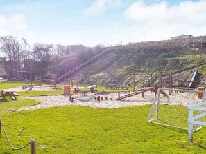 A playground with various equipment, a picnic table, and a soccer goal. - Cozy Holiday Home in Jutland near Sea (Lemvig)