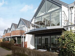 A modern building with large windows and a balcony.