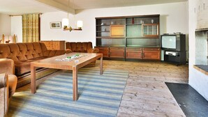 A living room with a brown sofa, a wooden coffee table, and a television. - 8 Person Holiday Home in Lonsboda (Lönsboda)