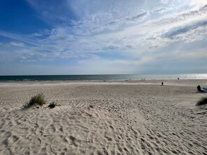 A wide sandy beach with gentle waves and a clear sky. - Cozy Holiday Home in BlÃ¥vand near Beach (Blavand)