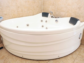 A white hot tub with a control panel and jets, set against a tiled wall. - 5 Star Holiday Home in Albaek (Aalbaek)