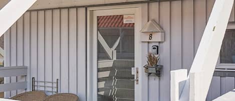 A building with a white exterior, a door with a DanCenter sign, and a mailbox.