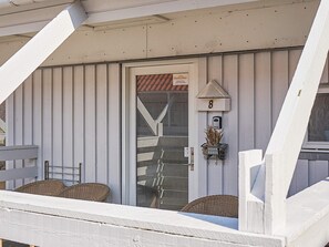 A building with a white exterior, a door with a DanCenter sign, and a mailbox. - Quaint Holiday Home in LÃ¸kken With Beach Nearby (Gudhjem)