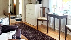 A room with a bed, a dresser, a chair, a table, and a window. - 6 Person Holiday Home in Vara (Vara)