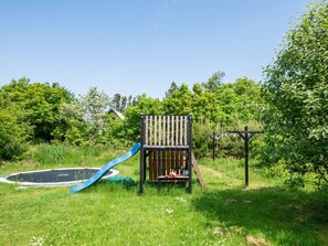 A playground with a slide and a climbing structure.