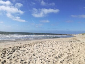 A sandy beach with footprints, a clear sky, and a calm sea. - 4 Star Holiday Home in Blavand (Blavand)