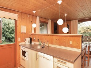 A wooden kitchen with a countertop, sink, and appliances. - Spacious Holiday Home In Struer near Ocean (Struer)