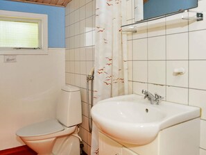 Kylpyhuone, jossa on wc, pesuallas, suihku ja ikkuna.