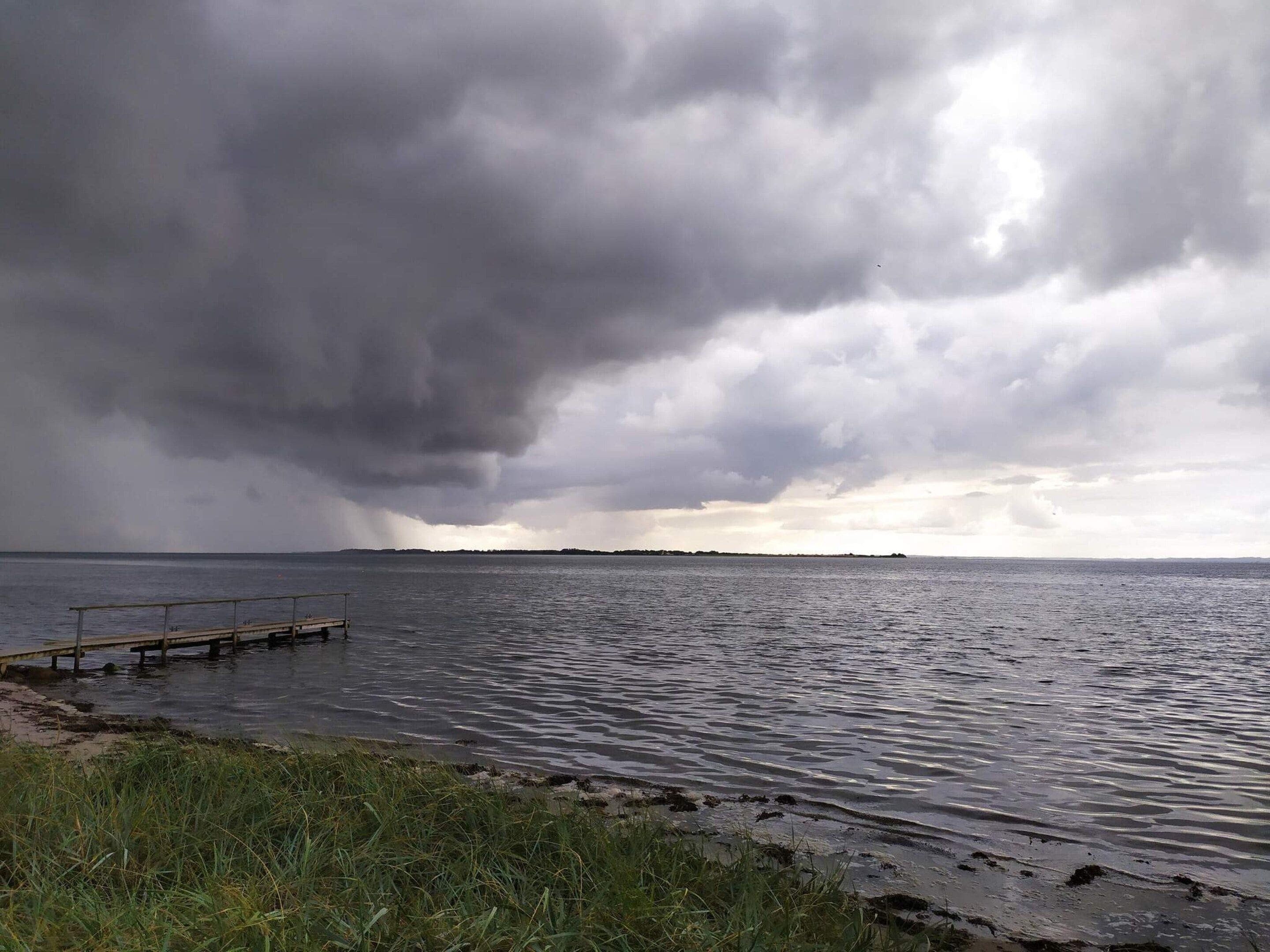 A body of water with a dock extending into it.