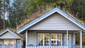 A small, single-story cabin with a gabled roof and a porch. - 4 Person Holiday Home in Folkestad (Volda)