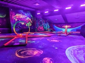 A room with a space-themed mural, a ceiling with a grid pattern, and a floor with circular designs. - Holiday Home in Wendtorf (Wendtorf)