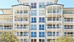 A multi-story hotel with balconies, large windows, and a symmetrical facade. - Holiday Home in Grossenbrode (Grossenbrode)