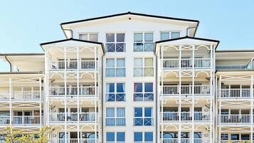 A multi-story hotel with balconies, large windows, and a symmetrical facade.