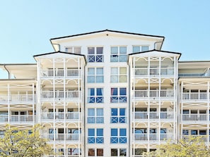 A multi-story hotel with balconies, large windows, and a symmetrical facade. - Holiday Home in Grossenbrode (Grossenbrode)