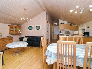 A cozy, compact living space with a dining area, kitchenette, and a sofa. - 6 Person Holiday Home in Skibby (Skibby)