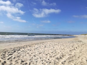 A sandy beach with footprints, a clear sky, and a calm sea. - 4 Star Holiday Home in Blavand (Blavand)