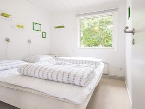 A bedroom with a bed, a window, and a door. - 6 Person Holiday Home in Kolind-by Traum (Kolind)