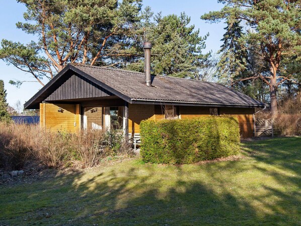 A rustic cabin with a sloped roof, a chimney, and a wooden exterior. - Rustic Holiday Home in Asnæs near Sea (Asnaes)