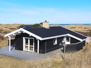 A modern black house with a flat roof, white trim, and a satellite dish. - 6 Person Holiday Home in Hirtshals (Hirtshals)