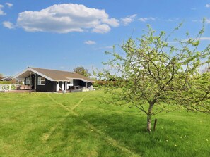 A house with a covered porch and a lawn.