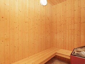 A sauna room with wooden walls and benches. - 4 Star Holiday Home in Hjorring (Hjørring)