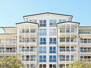 A multi-story hotel with balconies, large windows, and a symmetrical facade. - Holiday Home in Grossenbrode (Grossenbrode)