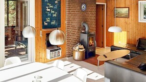 A cozy living room with a fireplace, a TV, and a dining area. - 6 Person Holiday Home in Norre Nebel (Norre Nebel)