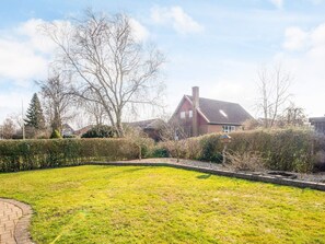 A residential property with a well-maintained lawn, a brick pathway, and a large house with a sloped roof. - 3 Person Holiday Home in Ansager (Ansager)