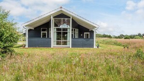 A single-story house with a gabled roof, large windows, and a front porch. - Picturesque Holiday Home in Ulfborg near Sea (Ulfborg)