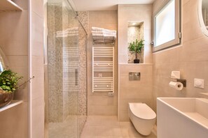 Bathtub, hair dryer, slippers, towels